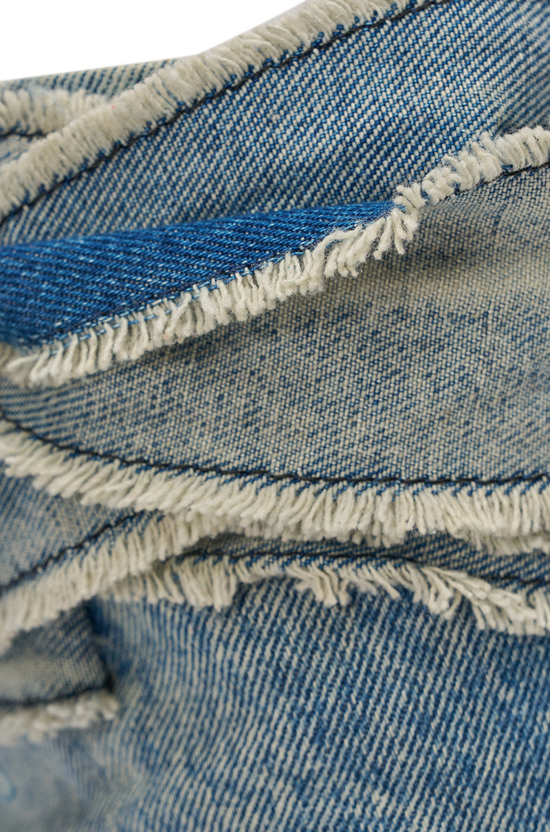 Close-up of the AZALEA WANG KARTER DENIM OPEN TOE BOOTIE, featuring light blue distressed denim with frayed edges and visible stitching, showcasing the textured weave typical of classic jeans. 7