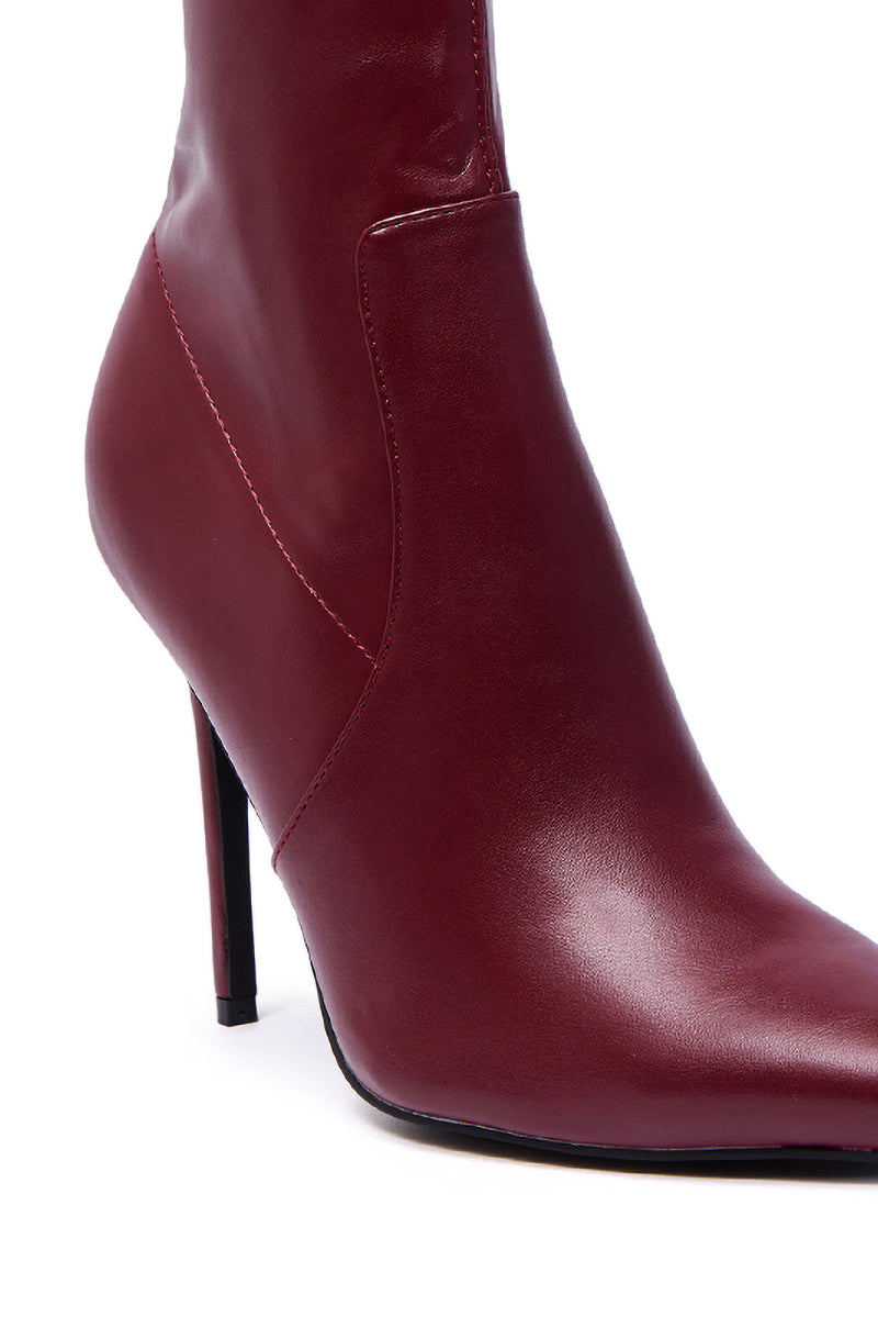 Close-up of the AZALEA WANG KATHII BURGUNDY BOOTIE, featuring a pointed toe, smooth faux leather finish, slim stiletto heel for added height, and accent side stitching details.
