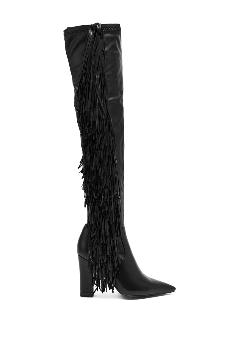 The AZALEA WANG KATRICIA BLACK FRINGE CHUNKY BOOT is a black, knee-high boot with a chunky heel, crafted from vegan leather and detailed with side fringe and a pointed toe. 3