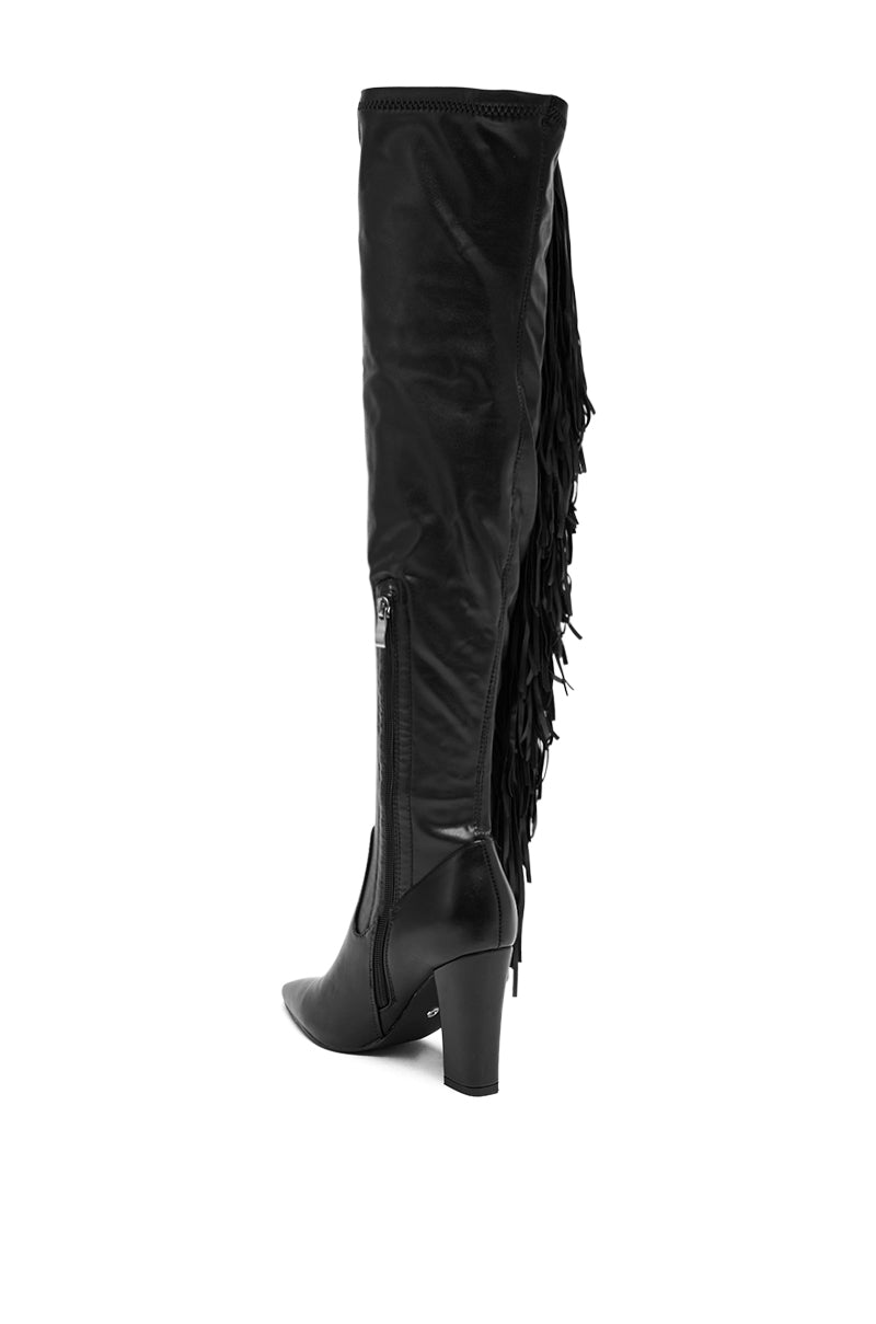 The AZALEA WANG KATRICIA BLACK FRINGE CHUNKY BOOT is a black, knee-high vegan leather boot featuring a pointed toe, chunky mid-height heel, side zipper, and decorative fringe along the back for stylish comfort. 5