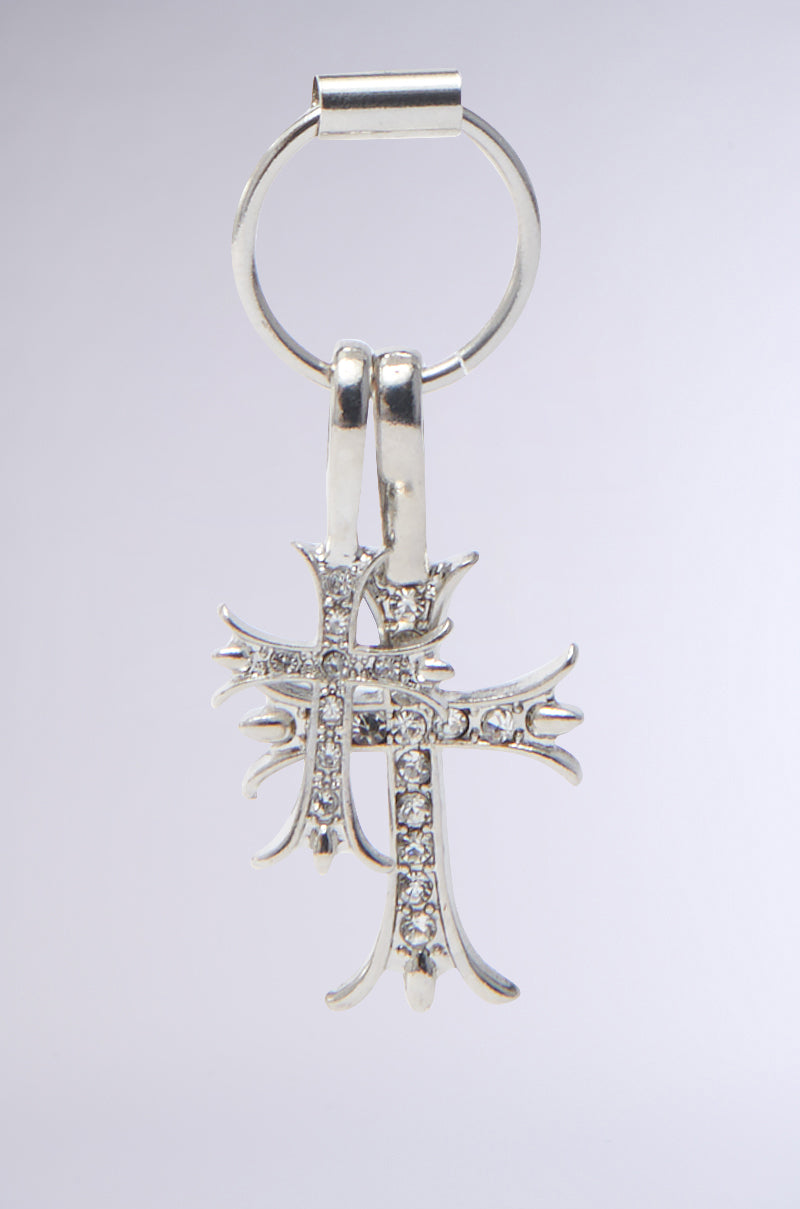 The CROSS CHARM EARRING is rhinestone-embellished with two intricately designed interlocking crosses adorned with small clear gemstones against a neutral background. 4