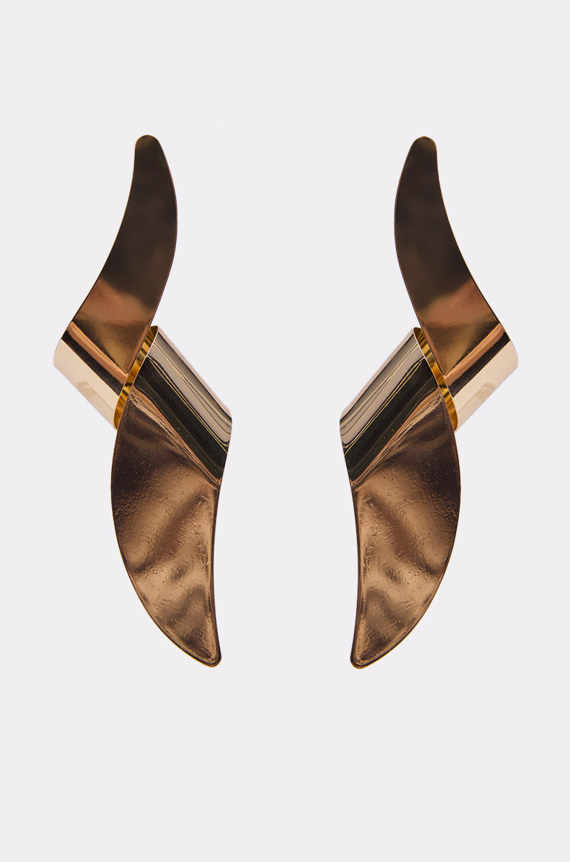 The TWISTED UP EARRING features a wavy, sculptural design in a gold-tone finish, displayed against a plain white background.