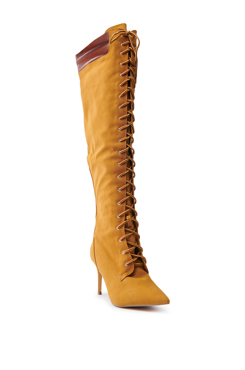 The KENDRIX SUEDE KNEE-HIGH BOOT features a stiletto heel, faux suede material, front lacing with brown laces, and a sleek design highlighted by brown leather detailing at the top.