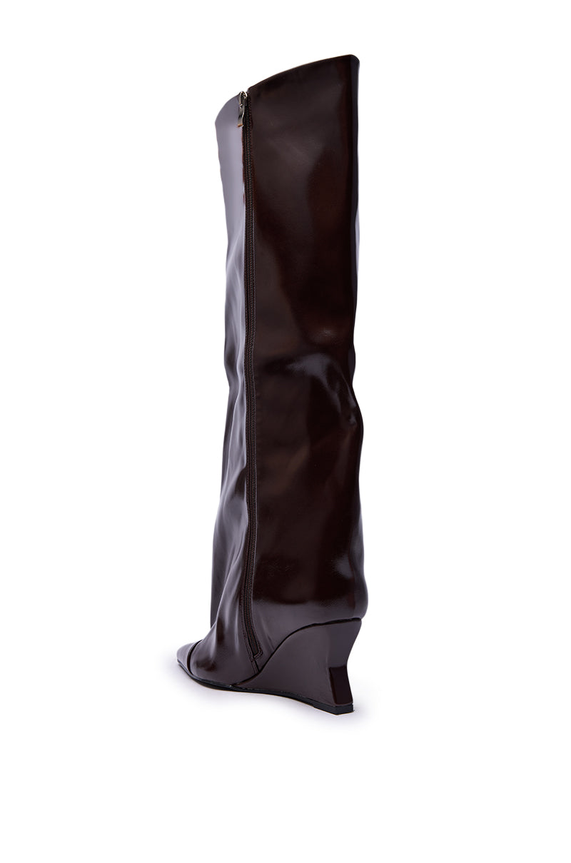 The AZALEA WANG KENYA Brown Knee High Wedge Boot features a tall faux leather design with a pointed toe and side zipper, shown on a white background.