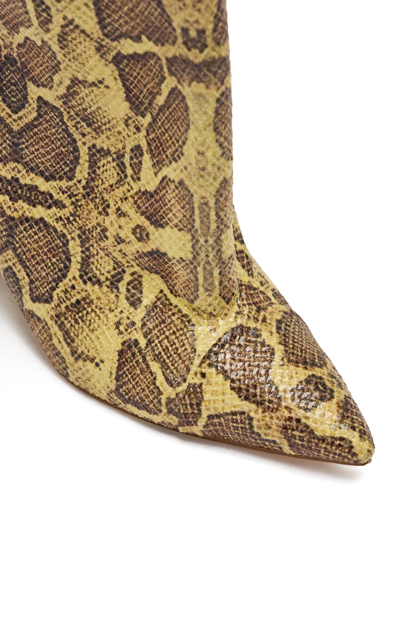 Close-up of the pointed toe on the AZALEA WANG KENYA YELLOW SNAKE PRINT KNEE HIGH WEDGE BOOT, featuring a bold yellow and brown snake print pattern—perfect for elevating any look.