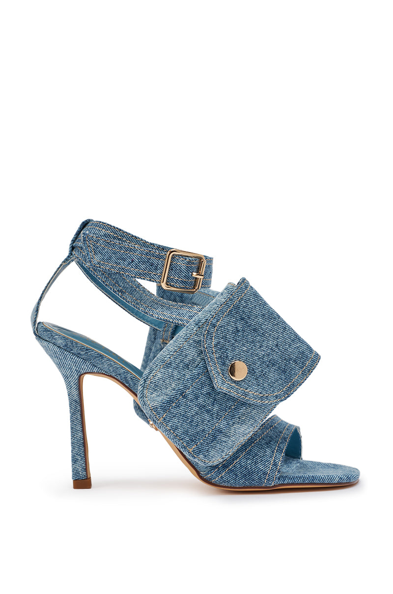 The AKIRA GOLD KERSHAW DENIM POCKET STILETTO STRAP SANDAL is a blue denim high-heeled sandal with a square toe, ankle buckle strap, and a large side cargo pocket detail with button. 6