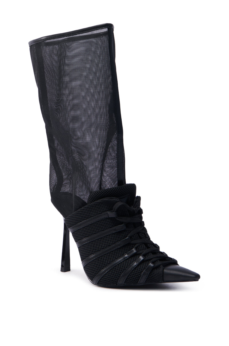 The AZALEA WANG ELLIS BLACK BOOTIE is a chic high-heeled bootie with a pointed toe, detailed black mesh upper, and crisscross strap design, paired with an elegant stiletto heel.