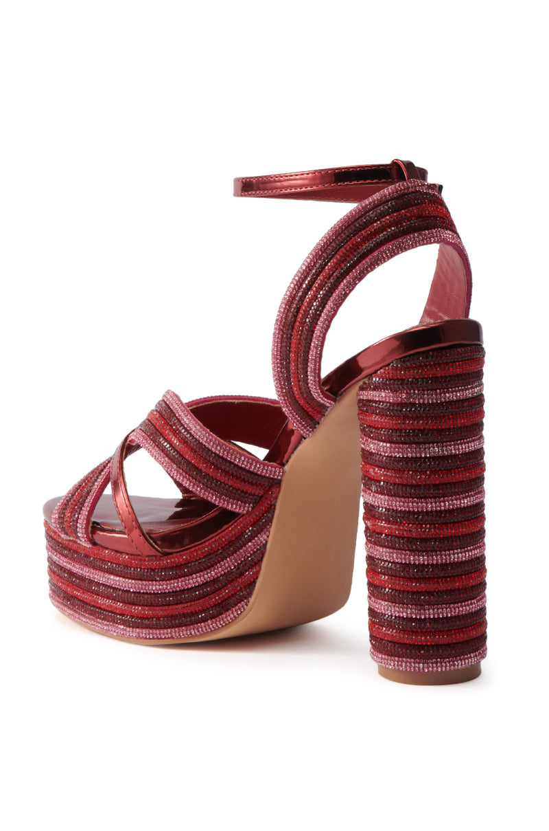 The AZALEA WANG KINSLEE BURGUNDY MULTI CHUNKY SANDAL features vibrant red tones, thick textured straps, rhinestone details, a chunky wrapped platform heel, ankle strap, and open toe design.