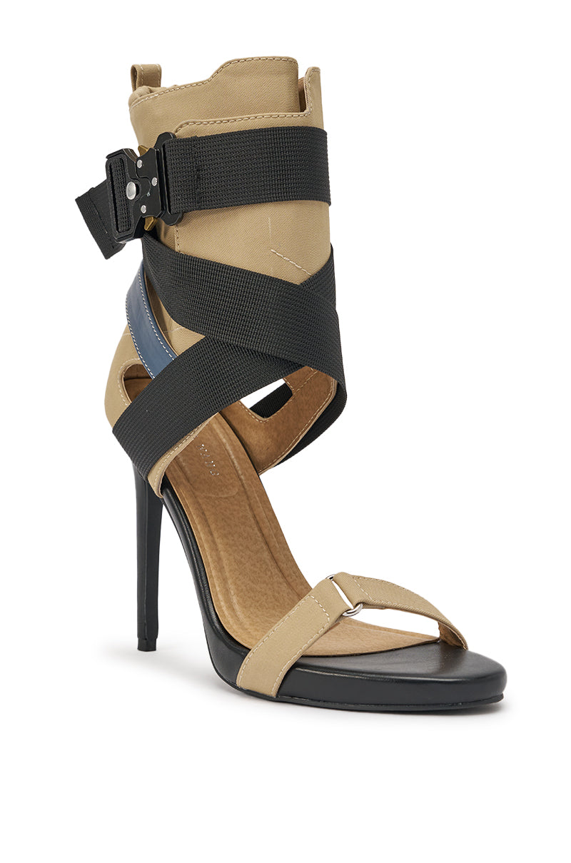 The AZALEA WANG KIVA KHAKI STILETTO SPORTY SANDAL features a black stiletto heel, tan crisscross elastic straps, a wide black ankle strap with buckle, and bold blue accents around the heel for a modern, edgy look. 4