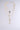 The CROSS LAYERED NECKLACE features four pendants on unique faux gold chains, including a rhinestone-studded cross, elegantly displayed on a plain gray background.