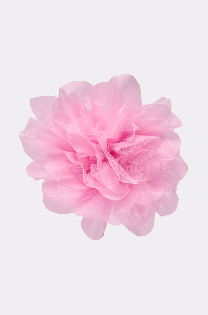 The OVERSIZED FLOWER STUD EARRING IN PINK features layered, petal-like details reminiscent of a decorative pom-pom, shown against a plain white background. 3