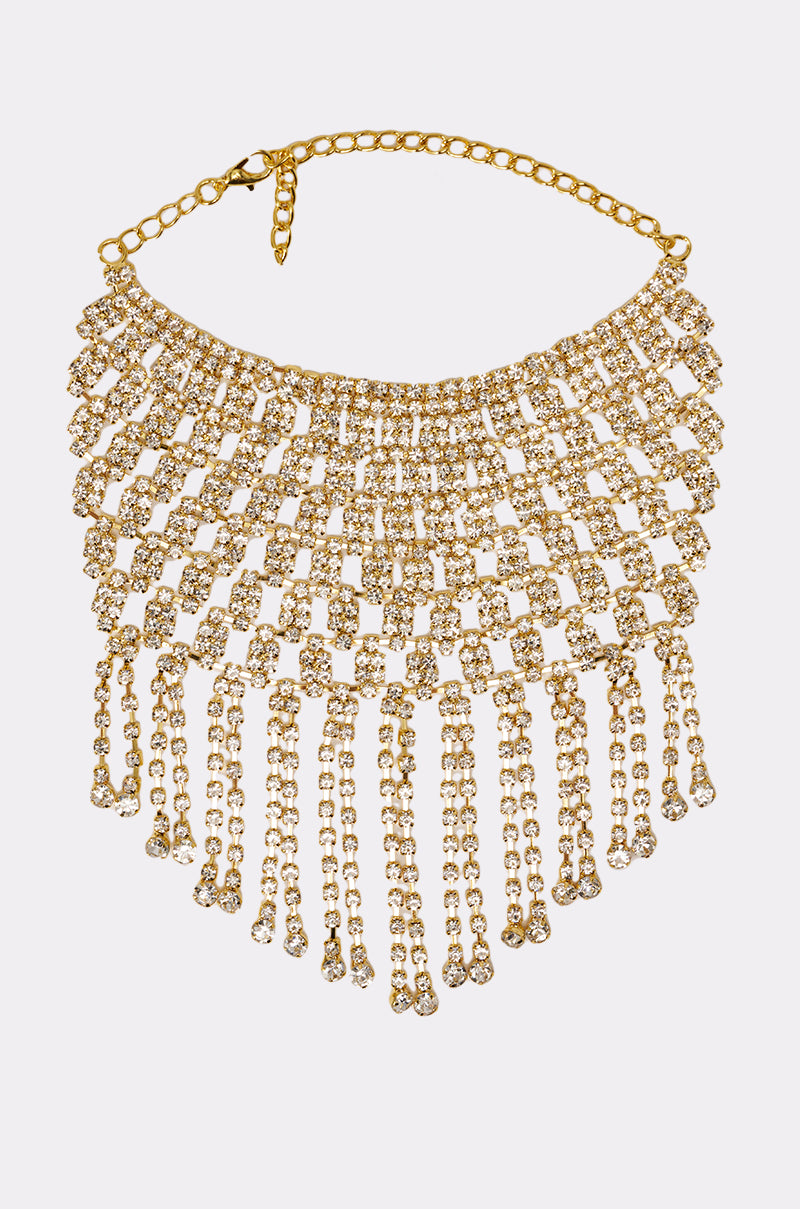 Pair the IN MY ERA BRACELET with a dazzling gold choker necklace embellished with rows of clear rhinestones and dramatic fringe-like chain details—an ideal combo for glamorous style. 1