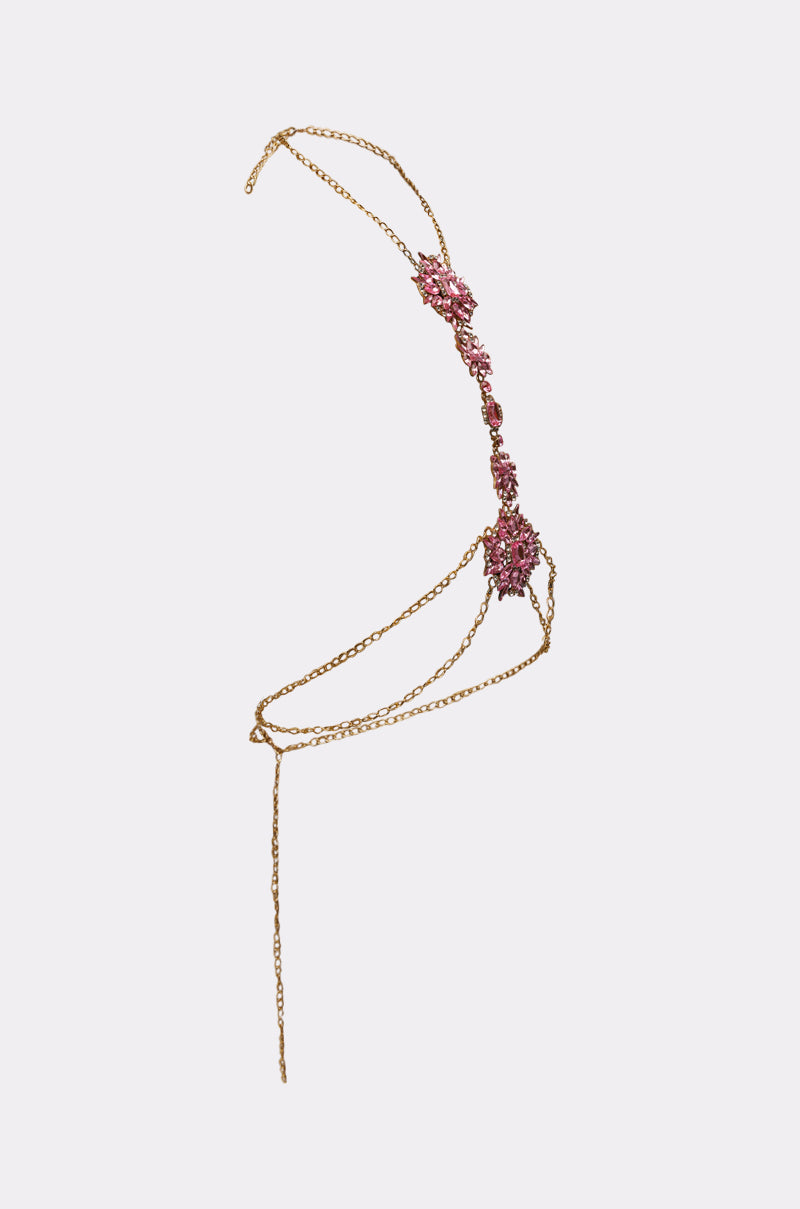 The PRETTY IN PINK BODY CHAIN is a delicate pink body accessory with intricate gemstone clusters, fine linked chains, and ornamental details, designed to drape elegantly across the torso. 2