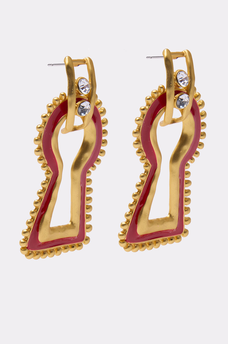 The UNLOCK ME EARRING features gold keyhole shapes with beaded edges and two clear rhinestones at the top of each, shown against a plain white background. 2