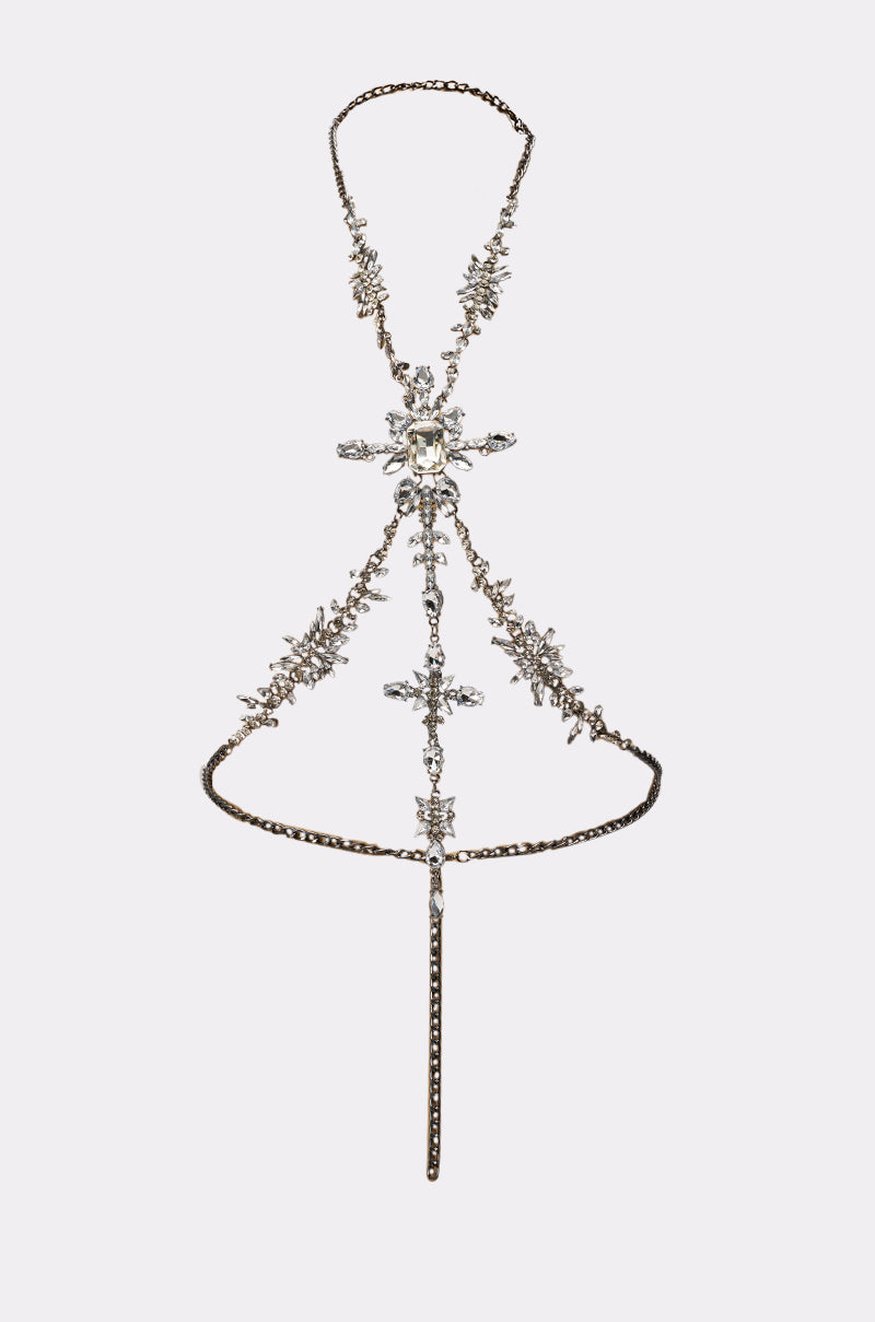 The LUXE ISNT CHEAP BODY CHAIN features sparkling rhinestones and clear crystals in floral and geometric patterns, a central pendant, thin chain straps, and delicate waist and neck loops for a stunning statement look. 4