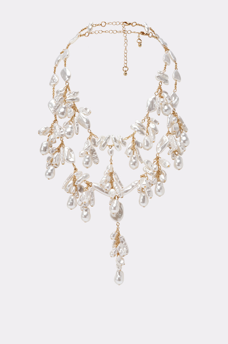 The WATERFALL NECKLACE SET features a gold multi-strand design with clusters of dangling white irregular-shaped pearls and an adjustable clasp, creating a dramatic cascading effect—ideal as elegant bridal jewelry.