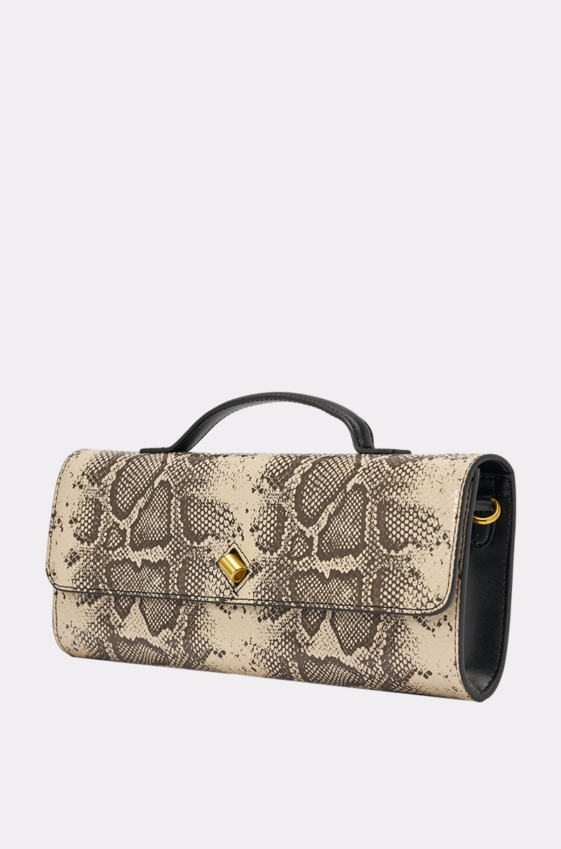 The I BITE PURSE is a rectangular bag featuring a beige and brown snakeskin print, black trim, a short black handle, and a gold square clasp, shown on a light background. 3