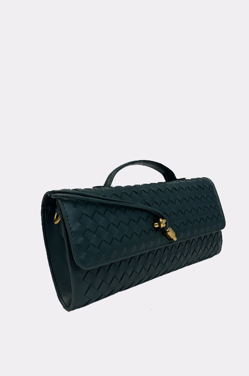 The LUXE LIFE PURSE is a black woven faux leather clutch with a short handle, gold clasp, and flap closure. Shown on a plain light background, it comes with an optional crossbody strap for versatile styling.