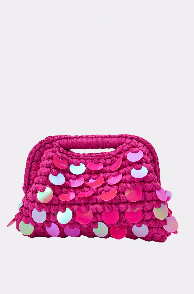 The ITS MY WORLD CROCHET SEQUIN CLUTCH is a vibrant pink, Y2K-inspired bag featuring a built-in handle and large iridescent sequins for standout sparkle. 2