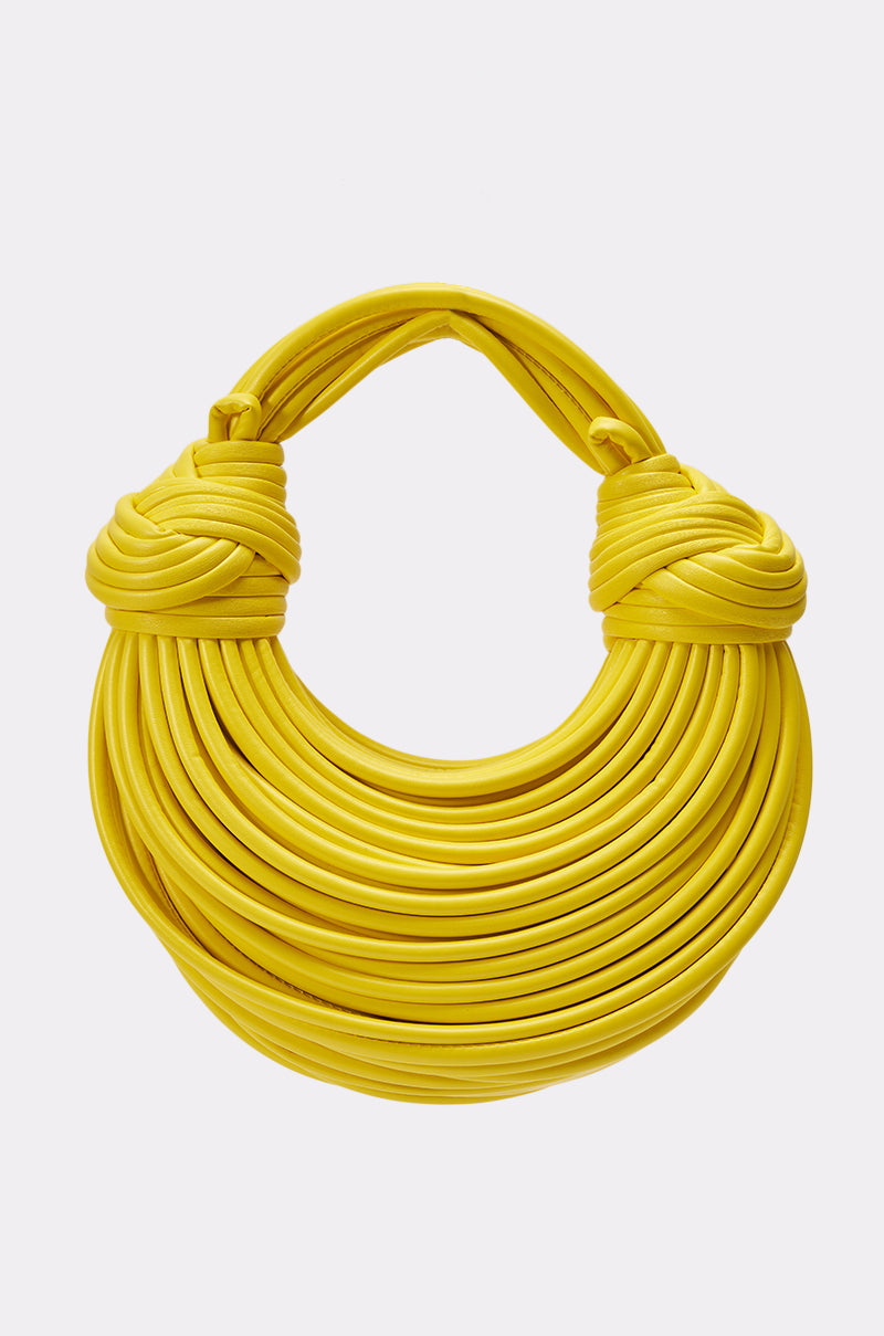 Make a bold statement with the BANANA SPLIT WHO PURSE—a round yellow fringe handbag with bright tubular strands, twisted and wrapped into unique handles. Photographed on a plain white background. 0