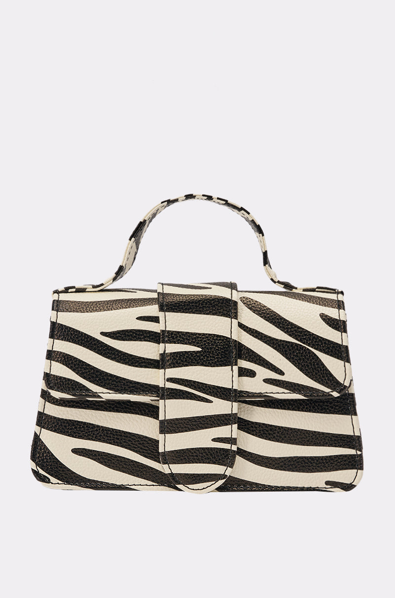 The LETS GET WILD ZEBRA BAG is a structured mini bag with a black and white zebra print, top handle, chain link strap, and front flap closure, shown against a plain light background. 0