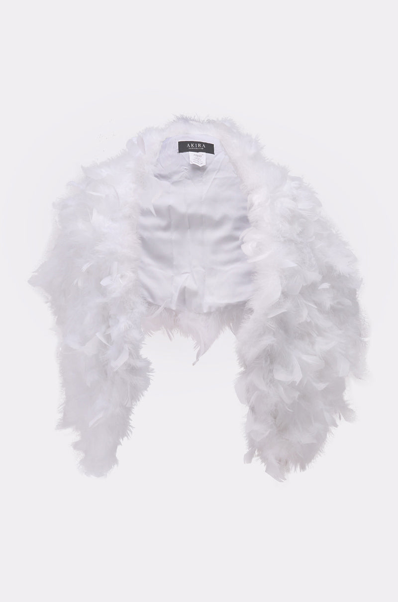 The TRUDY FEATHER WRAP is a white feathered bolero jacket featuring a satin lining and collar label, showcased against a plain light background for a vintage-inspired look. 2