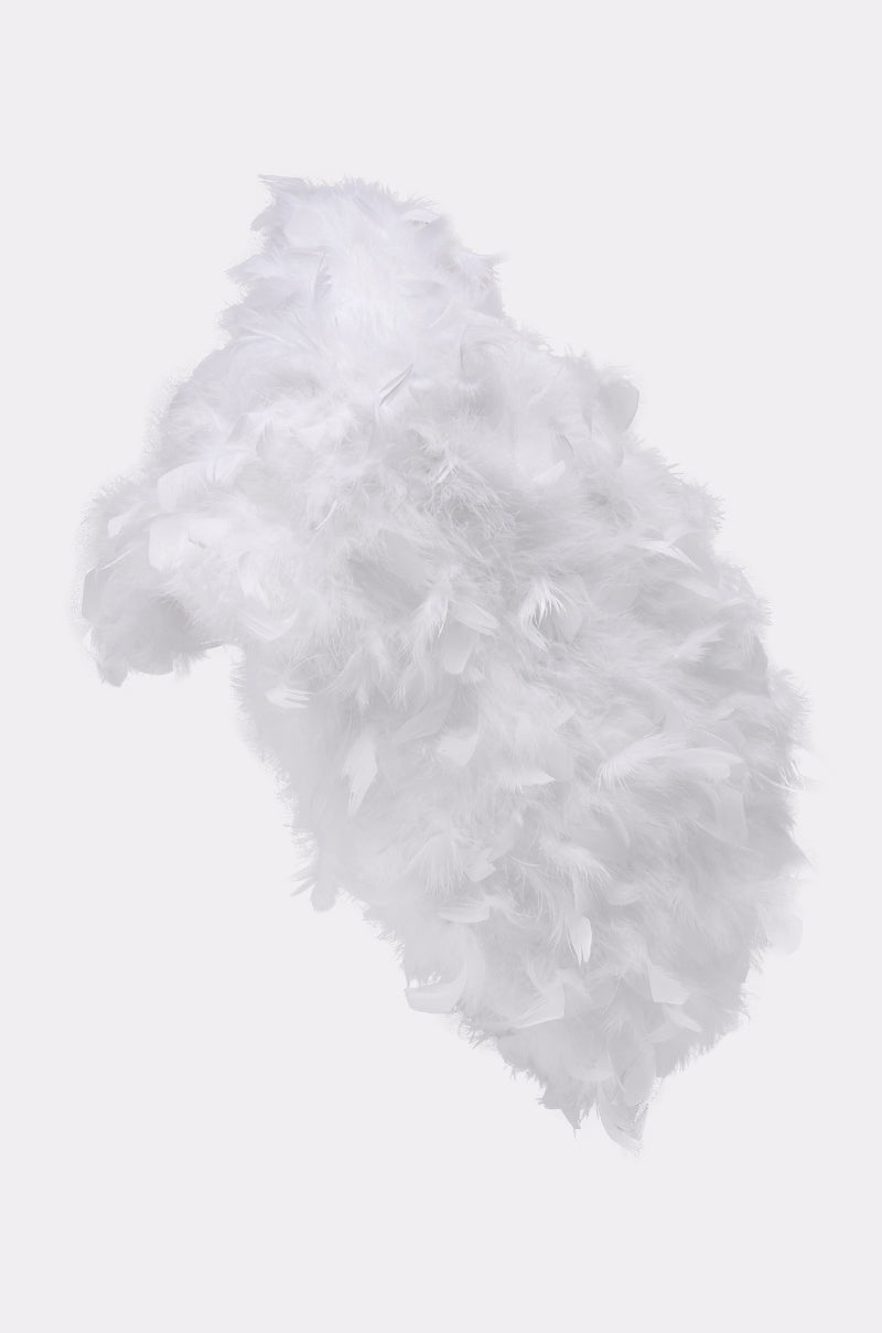 The TRUDY FEATHER WRAP, crafted from soft white feathers, makes an angelic statement piece when styled against a plain light background. 4