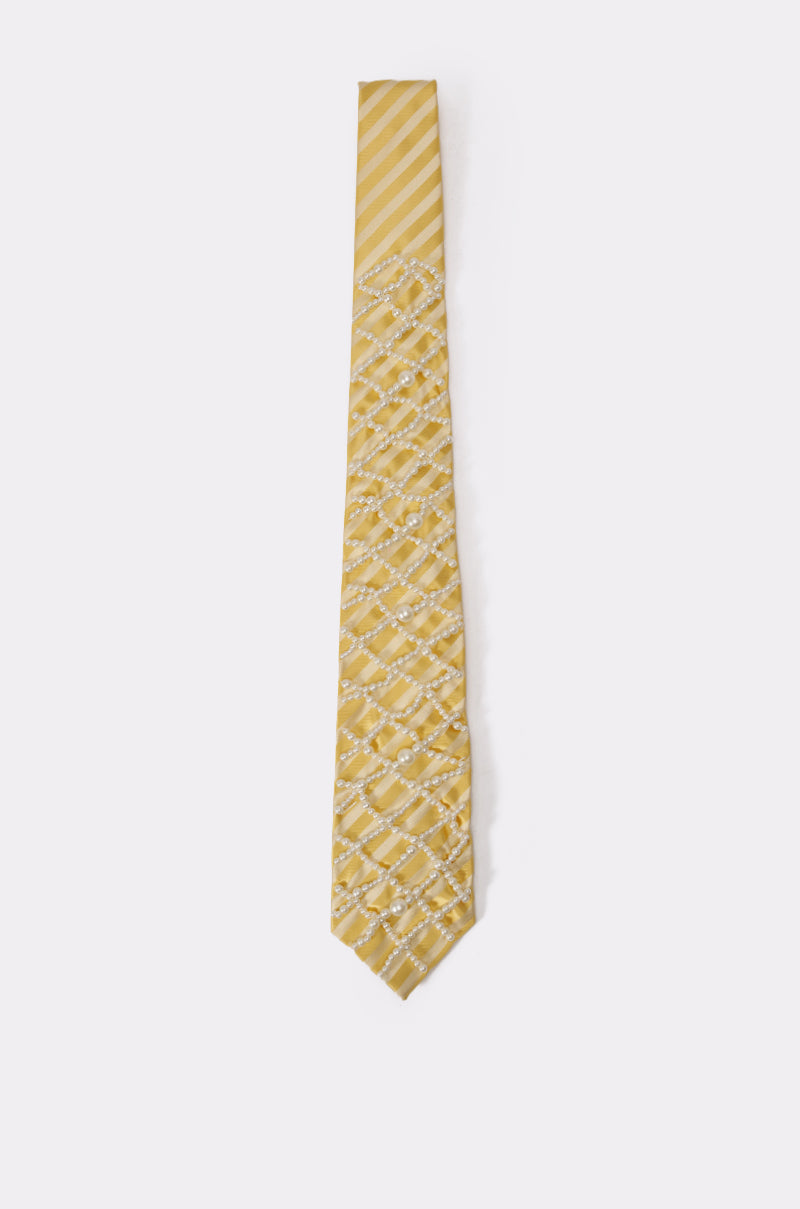 The FEMME APPLIQUE TIE is a butter yellow necktie with diagonal satin stripes and a crisscross white pearl diamond pattern, showcased on a plain white background. 4