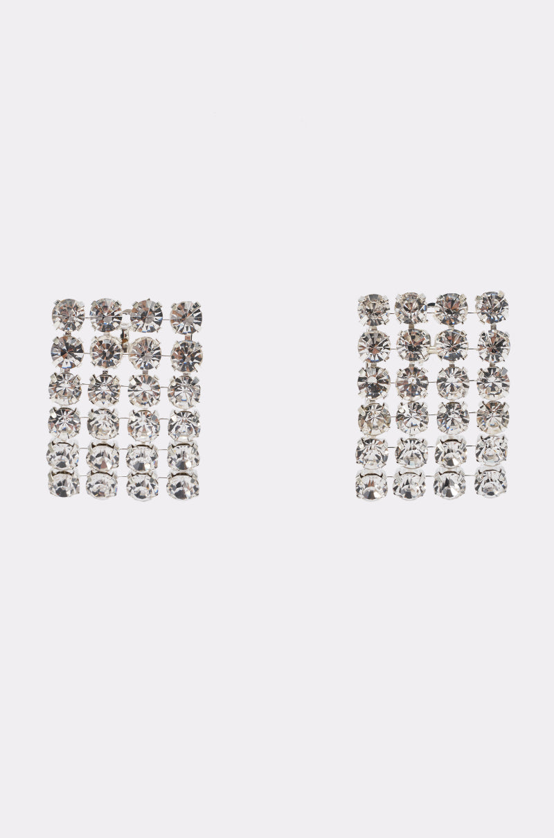 The ON THE RUNWAY STATEMENT EARRING features a bold, square-shaped design with four rows of clear, round rhinestones arranged in a grid pattern, showcased against a plain white background.