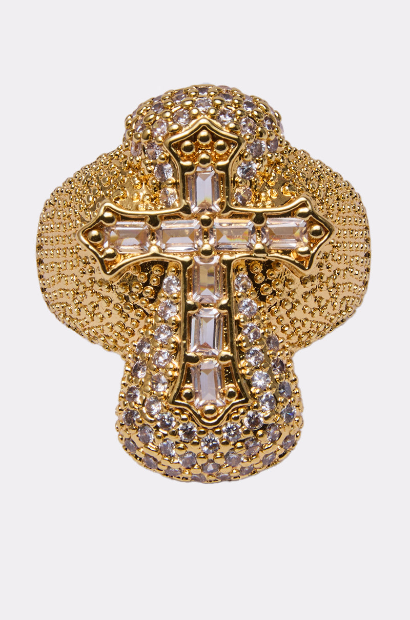 The LUXE CROSS RING is a faux gold ring featuring a cross adorned with small round gemstones, rhinestone detailing, and rectangular clear stones, shown against a plain white background. 0