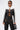 Wearing the WEST LOOP RACER MOTO black and white cropped jacket, high-waisted lace-up black pants with sheer panels, sunglasses, and holding a small black handbag, a woman stands confidently against a plain white background.