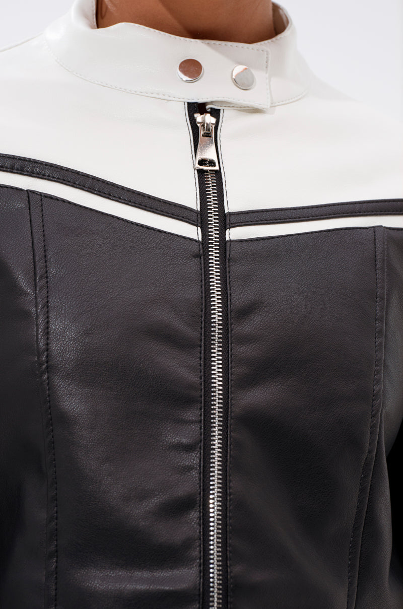 Close-up of the WEST LOOP RACER MOTO, a black and white faux leather moto jacket featuring a front zipper, silver snap buttons at the collar, and contrast white trim across the chest.