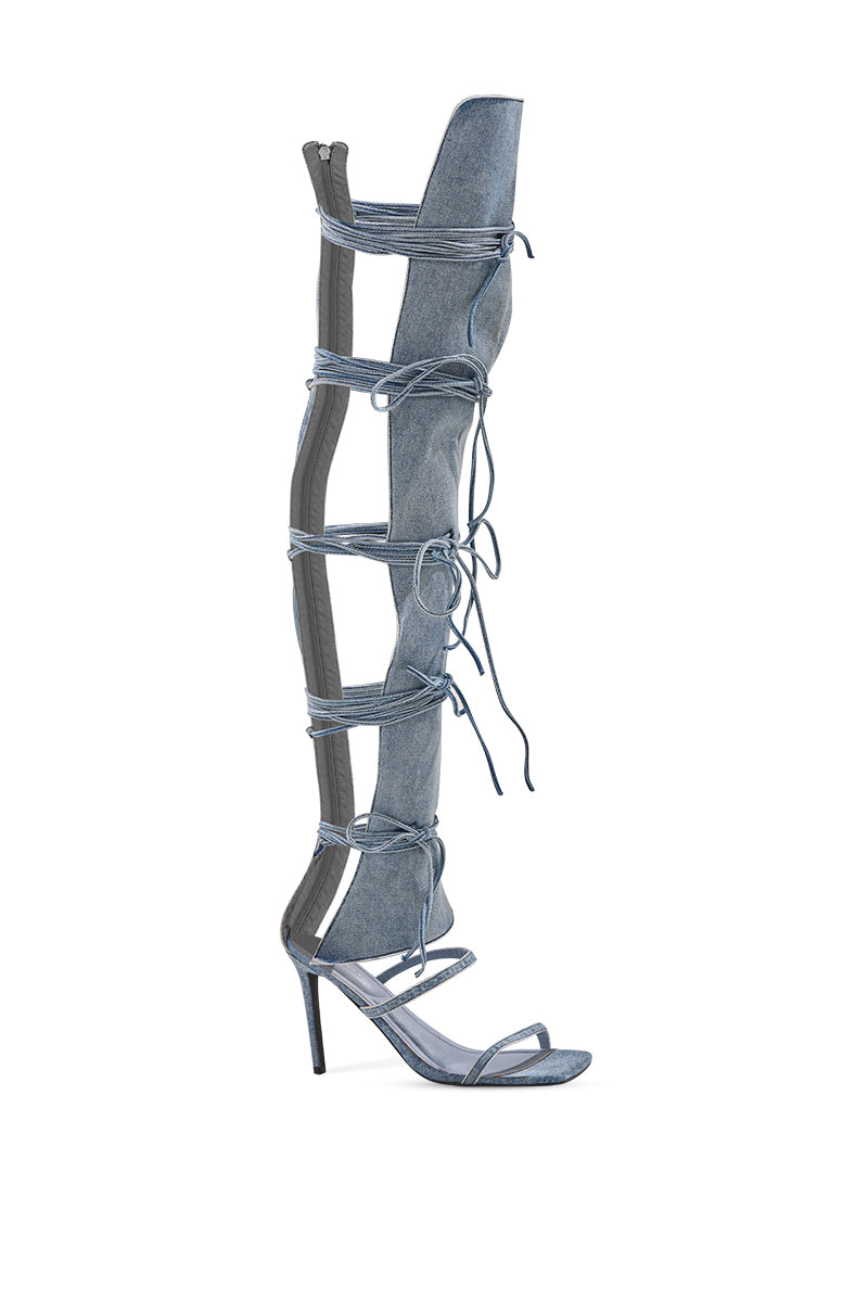 The AZALEA WANG KRISTINE DENIM STILETTO GLADIATOR SANDAL features an open square toe, multiple knee-high straps with laces, a back zip closure, and a bold stiletto heel.