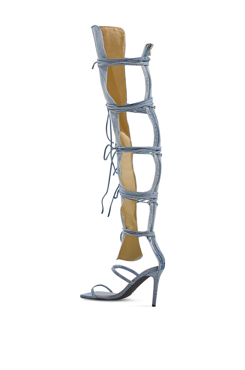 The AZALEA WANG KRISTINE DENIM STILETTO GLADIATOR SANDAL is a tall, light blue denim knee-high with a high stiletto heel, open square toe, multiple horizontal straps, and front lace-up details.