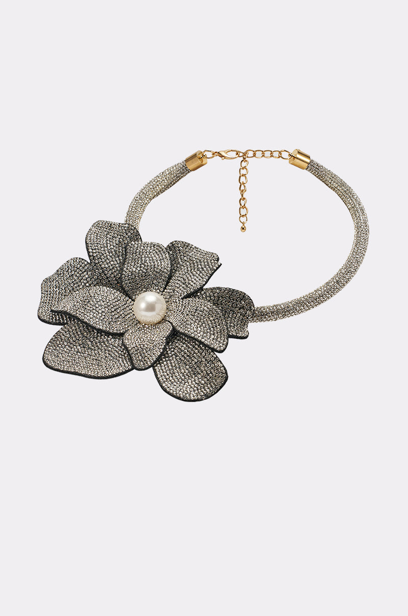 The HOLIDAY READY NECKLACE is a sparkling silver rhinestone collar with a large fabric flower featuring a pearl center and gold adjustable clasp, shown on a plain light background. 0