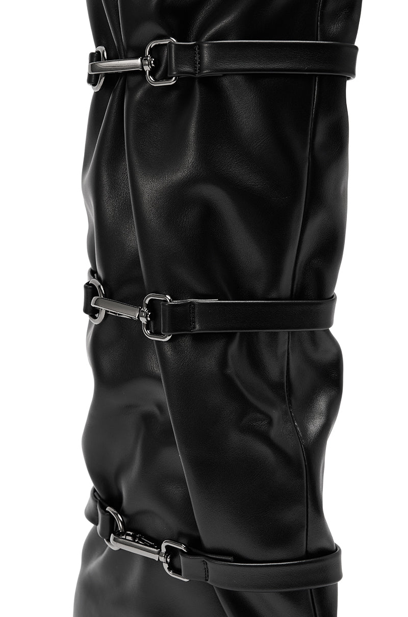 Close-up of the AZALEA WANG KULLERVO BLACK SILVER CLASP DETAIL WEDGE BOOT featuring black faux leather, multiple silver buckles, and horizontal straps for a sleek, modern look.