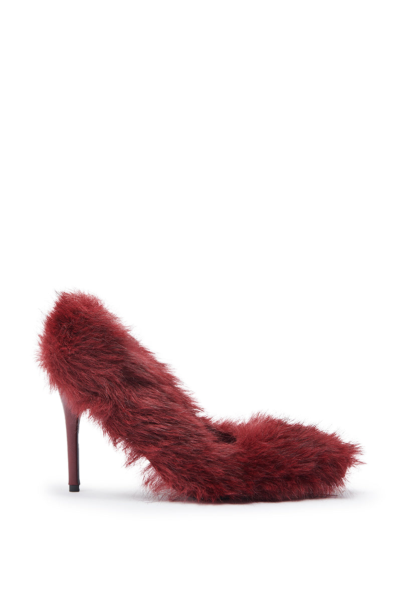 The AZALEA WANG KURT BURGUNDY FUR EMBELLISHED PUMP features a high stiletto heel and faux fur upper, displayed in profile against a white background.
