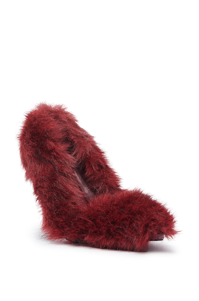 The AZALEA WANG KURT BURGUNDY FUR EMBELLISHED PUMP, a stiletto heel with deep red faux fur upper, is showcased elegantly against a plain white background.