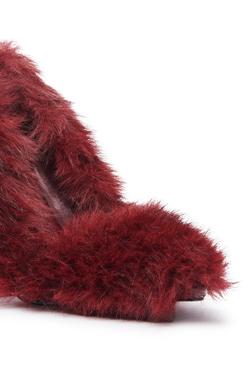 Close-up of the AZALEA WANG KURT BURGUNDY FUR EMBELLISHED PUMP, showcasing its stiletto heel, pointed toe, and deep burgundy faux fur upper against a white background.
