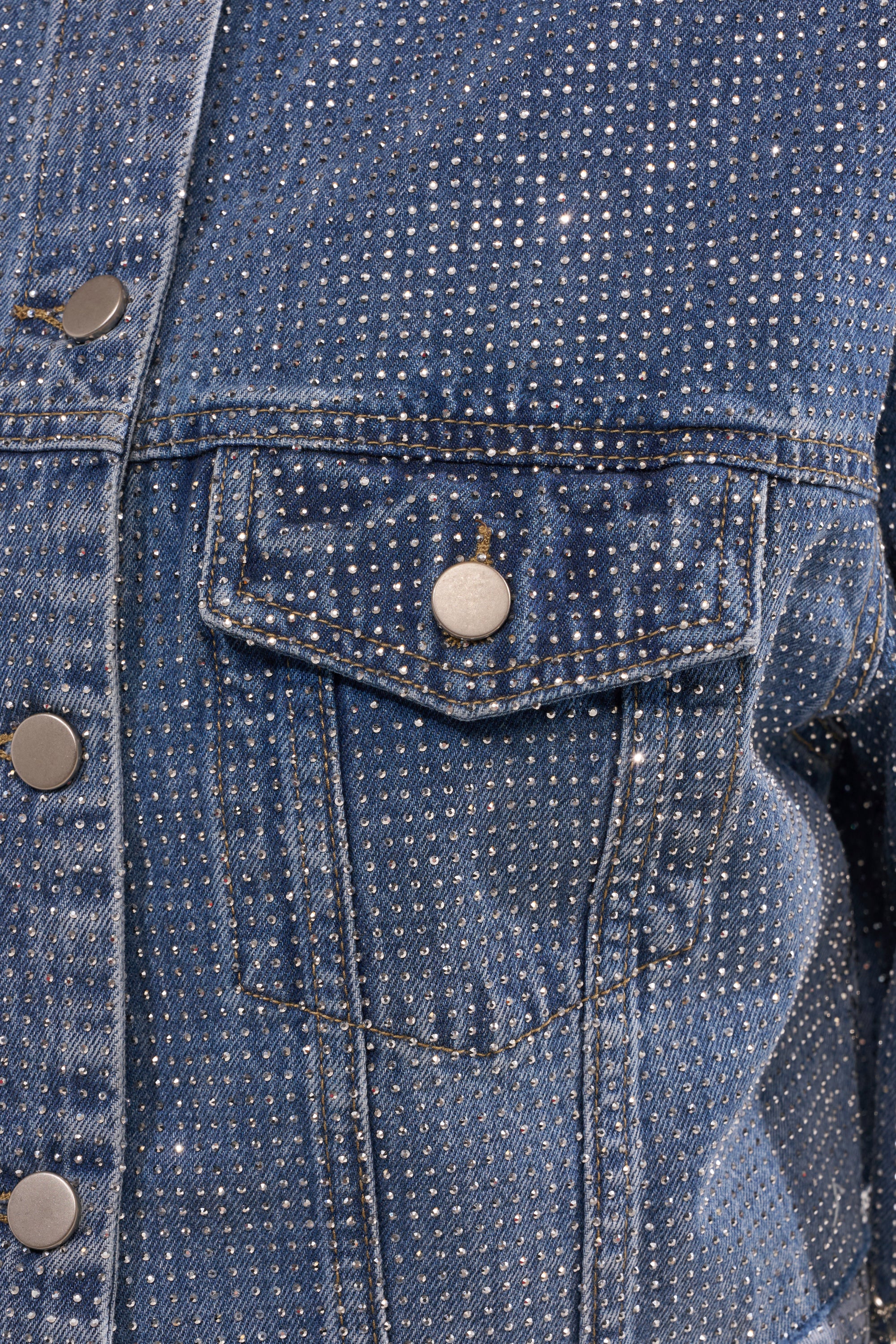 Close-up of the KYLIE EMBELLISHED DENIM JACKET pocket, featuring metal buttons and small, evenly spaced silver rhinestones for a sparkling effect. 10