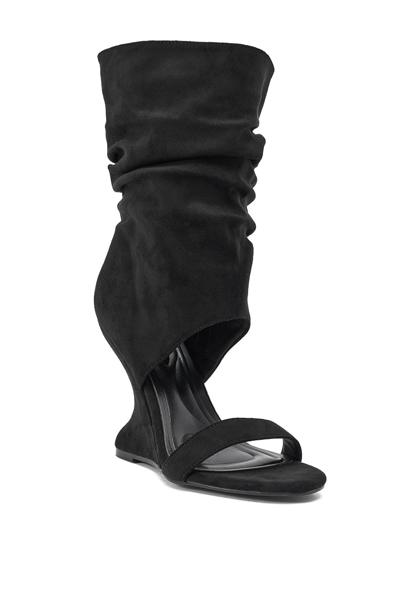 The AZALEA WANG KYVELISA BLACK WEDGE OPEN TOE BOOTIE features a flat black sole, open toe, wide front strap, and a tall, slouchy asymmetrical faux suede upper—ideal for fans of unique slouch boot sandals. 3