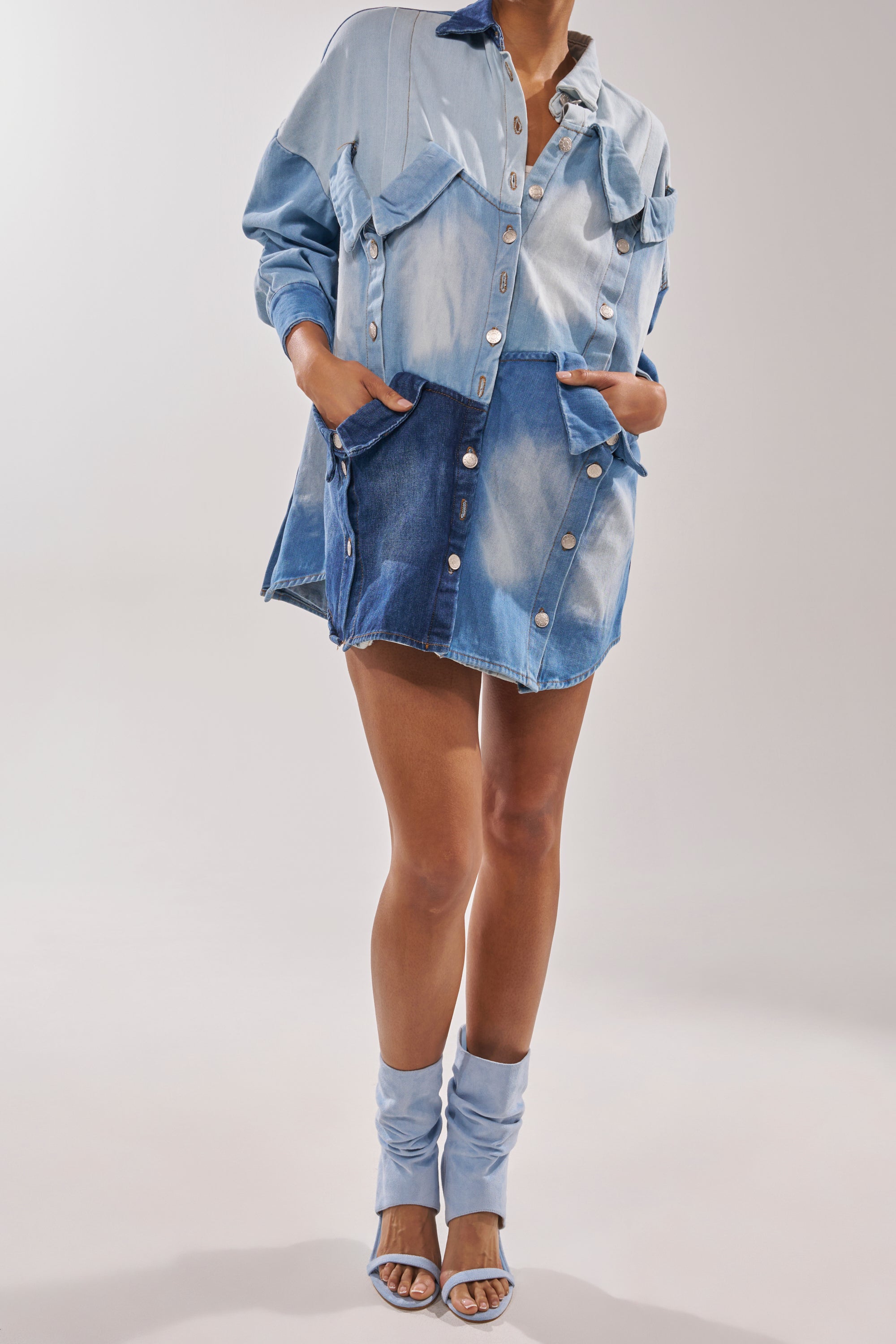 A person wearing a light and dark washed denim jacket, a matching button-front denim skirt, and the AZALEA WANG KYVELISA BLUE WEDGE OPEN TOE BOOTIE stands against a plain background. 2