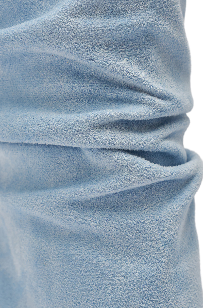 Close-up of soft, textured light blue fabric with visible folds and creases, reminiscent of the plush material on the AZALEA WANG KYVELISA BLUE WEDGE OPEN TOE BOOTIE's slouchy ankle cuff. 7