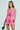 A person in an ELLE TWEED MINI DRESS channels Legally Blonde vibes with a small black handbag and sleek, straight hair, posing against a plain light background.