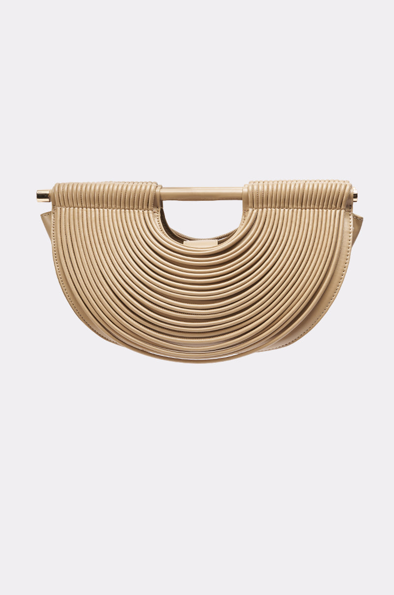 The CRESCENT CARRY-ALL PURSE by AKIRA Label features a beige ribbed, layered texture and a small horizontal top handle, shown on a plain light background. 1