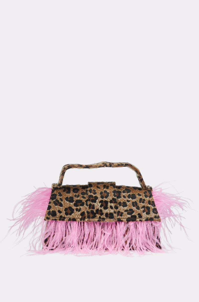 The TOO WILD FEATHER PURSE features a leopard print, fluffy pink feathers along the bottom and sides, and a rectangular handle.
