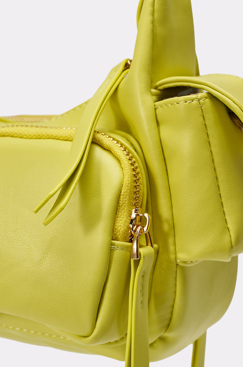 Close-up of the LIFE GIVES YOU LEMONS PURSE—a neon yellow shoulder bag in soft leather, featuring a gold zipper with a leather pull tab, detailed stitching, and utility pockets for easy organization. 5