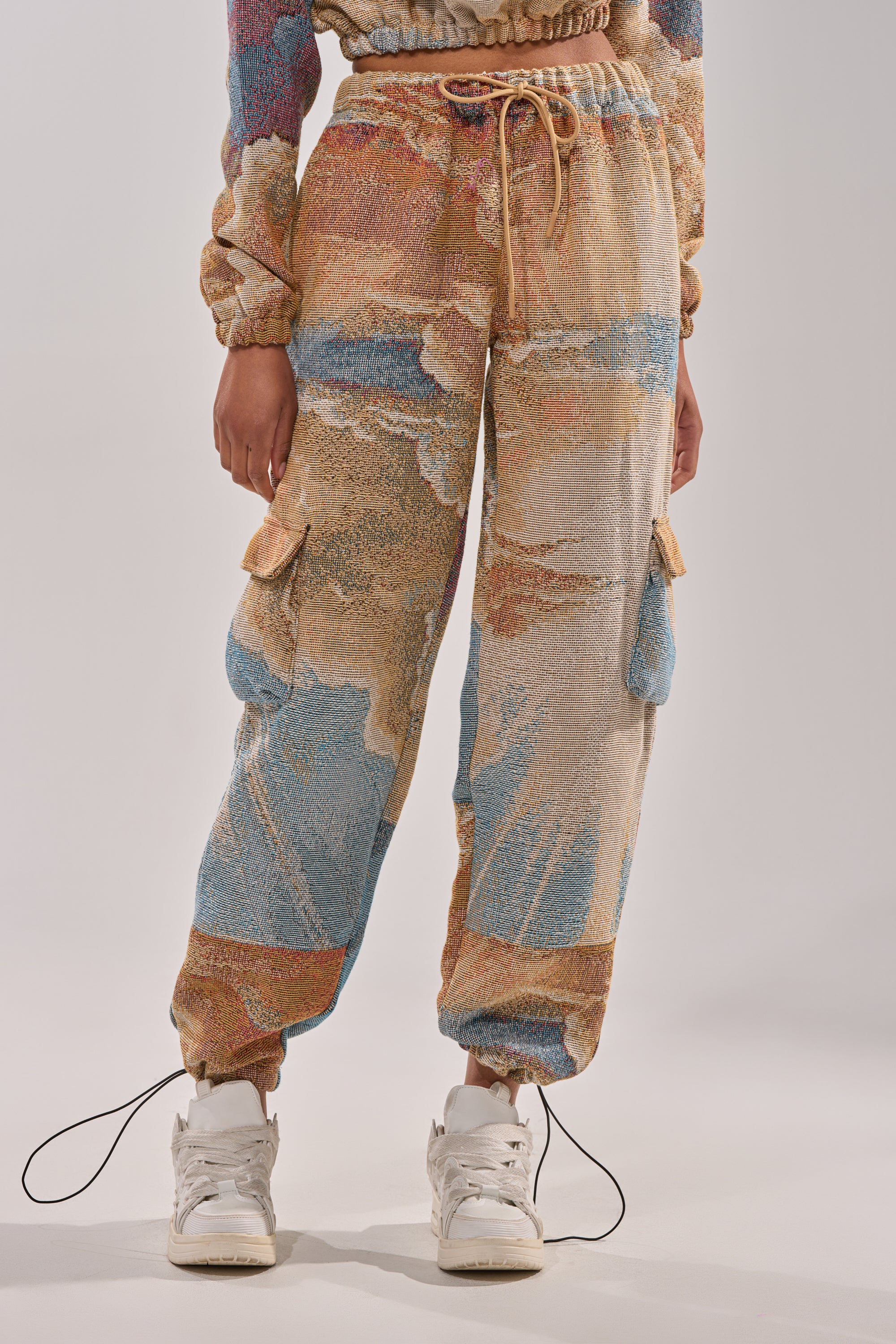 A person wearing INTO THE WILD WIDE LEG JOGGER pants. 1
