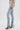 A model wearing the LACE IT UP SKINNY DENIM PANT with ruched skinny fit and zippered hems, paired with high-heeled sandals, is shown from the waist down against a plain white background.
