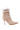 The AZALEA WANG LACIE SUEDE BOOTIE is a stylish high-heeled suede bootie with a pointed toe, featuring a beige faux suede body and white accents. It boasts white laces at the front and two wide beige Velcro straps at the top. The slim stiletto heel matches in color, while the sole is light brown.